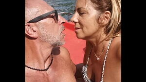 On the boat with my I give him a hand job and he ejaculates on my face